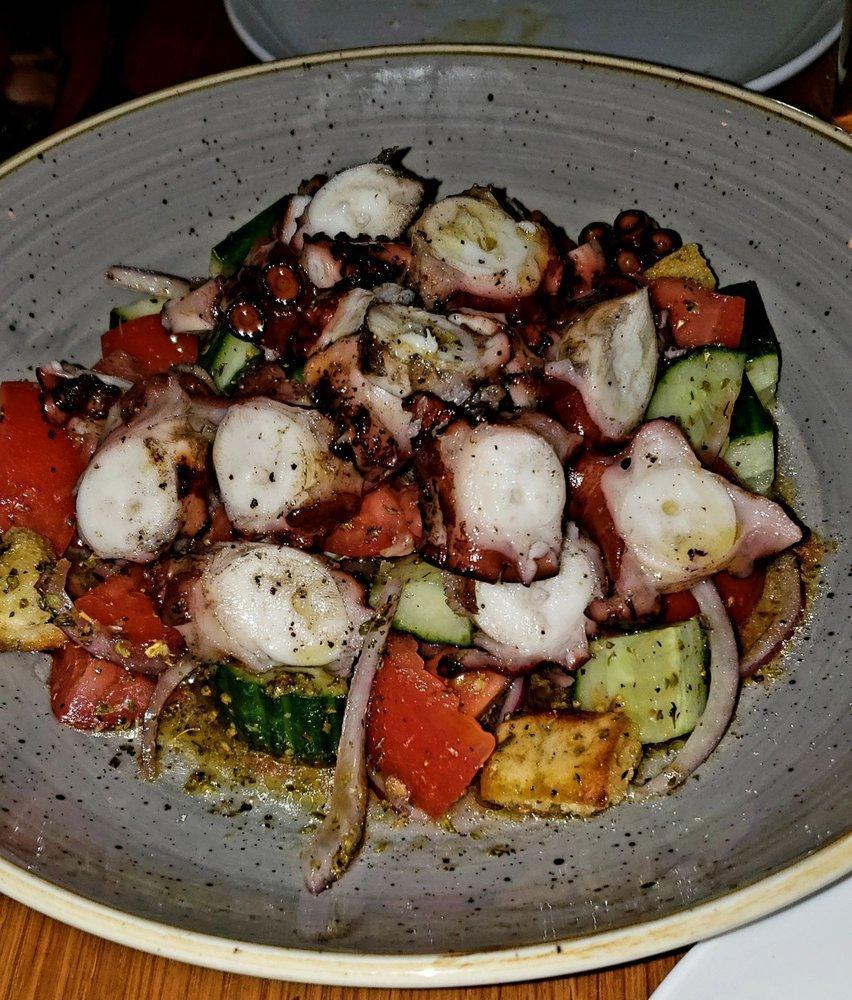 Grilled Octopus Salad · Grilled octopus, Roma tomatoes, cucumber, red onions, fresh squeezed lemon juice, EVOO, oregano,
