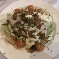 Wedge Salad · Iceberg lettuce, pancetta, fresh tomatoes, pecans, croutons, with a gorgonzola blue cheese d...