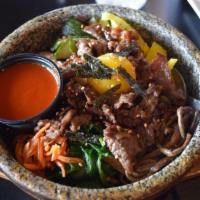 Bibimbap · Choice of protein, white rice and assorted seasonal vegetables topped with egg and served in...