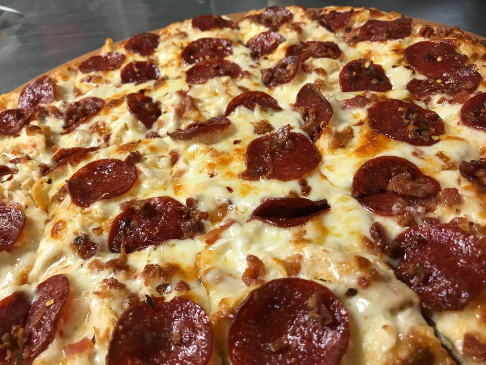 Gourmet Chicken Pizza · Alfredo sauce, chicken, all beef pepperoni, bacon, and garlic; sprinkled with crushed red pepper.
