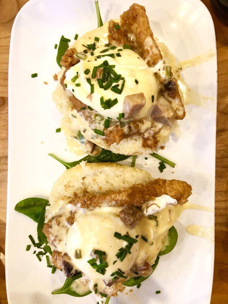Chicken St Charles · Fried chicken over a buttermilk biscuit, topped with two poached eggs and finished with pork tasso cream sauce