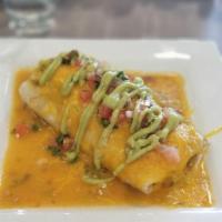 Smothered Burrito · Cage free eggs, potatoes, breakfast sausage, cheese, pico, smothered in pork or vegetarian g...
