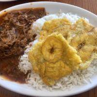 Cuban Ropa Vieja · Shredded beef, rice, black beans and tostones.
