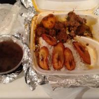 Cuban Carne Guisada · Stewed beef with rice, black beans and fried plantains. 