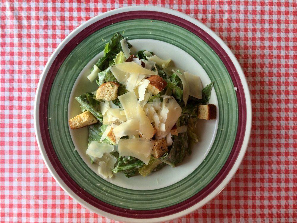 Caesar Salad · Romaine lettuce with Caesar dressing, homemade fresh croutons and shaved imported Reggiano Parmigiano cheese.