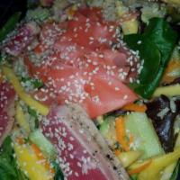 Grilled Ahi Tuna Salad · Baby mixed greens, brown rice, mangos, avocado, cucumber, carrots, ginger with a soy ginger ...