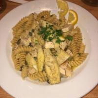 Chicken Limone · Roasted chicken breast, artichokes, capers, fresh lemon butter sauce, garlic. Served on fusi...