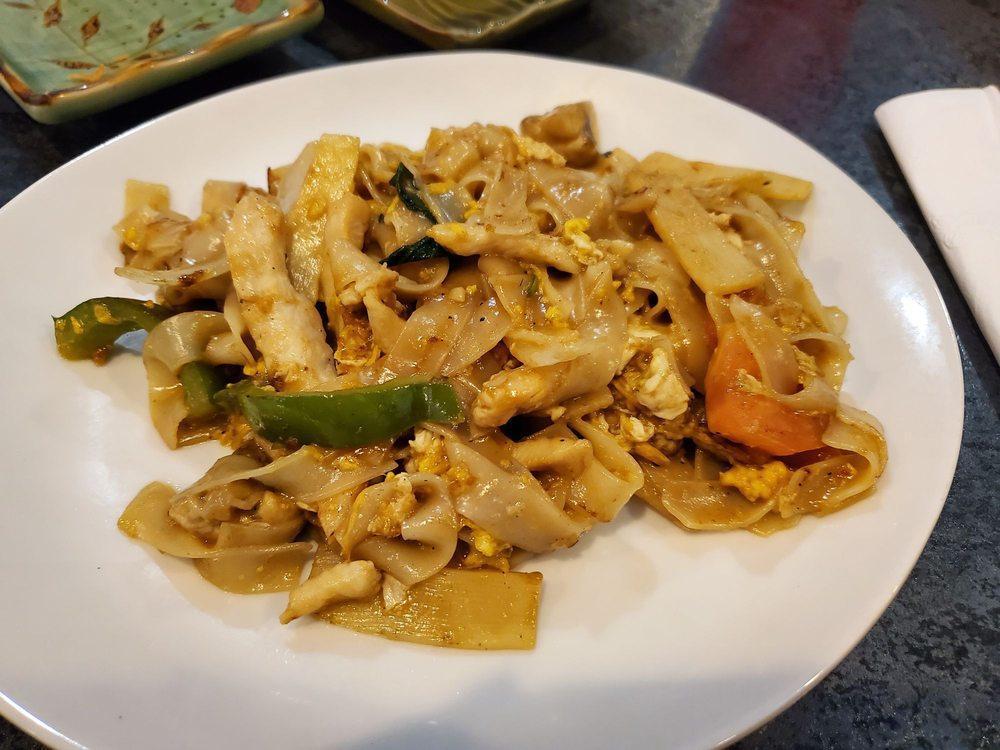 Drunken Noodles · Wide rice noodles fried with egg, onions, bamboo shoots, mushrooms, bell peppers, garlic, tomatoes, chili paste, and fresh basil leaves.
