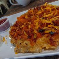 Bacon Tater · Hash brown waffle, cheddar cheese and bacon, sprinkled with black pepper and served with sid...