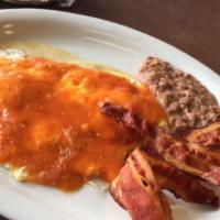 Huevos Rancheros · 2 eggs any style, covered in our zesty ranchero sauce and 1 meat.