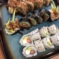 Spider Roll · Soft shell crab deep fried, cucumber, avocado, spicy mayo, and masago inside, eel sauce on t...