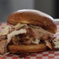 Pulled Pork Sandwich · Smoked pulled pork, coleslaw and BBQ sauce.