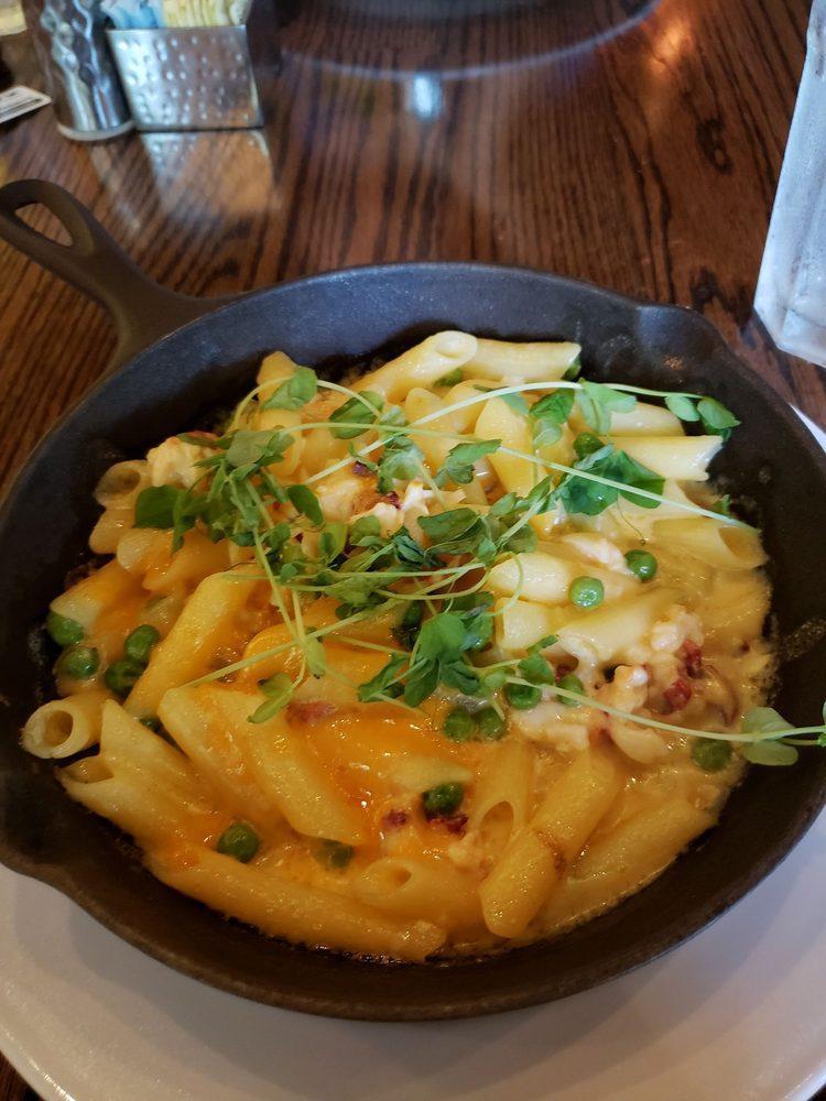 Benstein Lobster Mac Pasta · Cavatappi pasta smothered in a Pinconning cheese blend and lobster meat topped with roasted garlic crumbles and fresh greens.