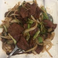 Mongolian Beef · Sliced beef stir fried with green and yellow onion in a spicy hoisin sauce. Served with 1 eg...