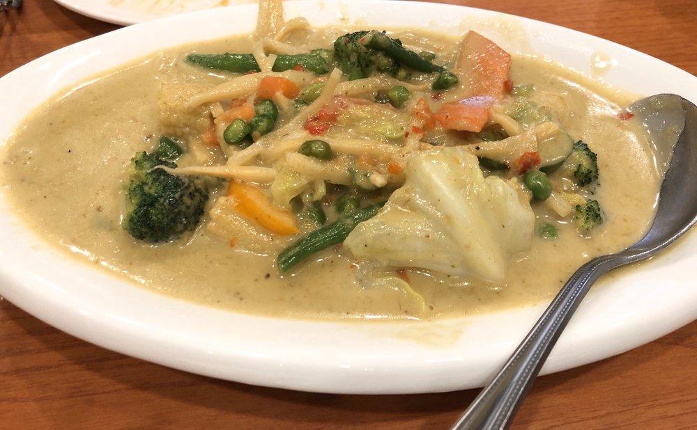 Green Curry · Cooked in green curry sauce, bamboo shoots, bell peppers, and sweet basil.