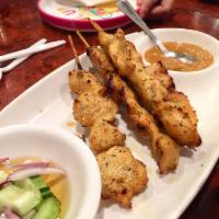 Chicken Satay · Marinated and grilled chicken on skewers, served with peanut sauce and cucumber salad.
