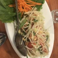 Papaya Salad · Shredded green papaya, green beans, seasoned with Thai style and mixed with dry shrimp, pean...