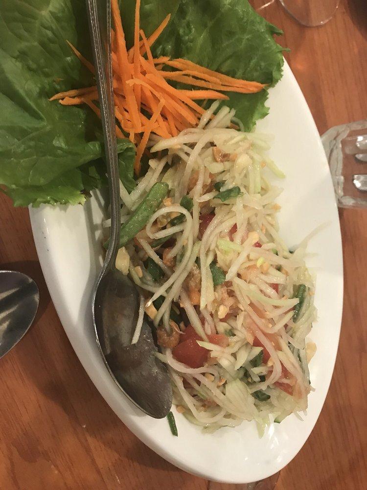 Papaya Salad · Shredded green papaya, green beans, seasoned with Thai style and mixed with dry shrimp, peanuts, and tomatoes, served over lettuce.