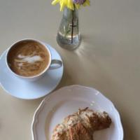 Almond Croissant · Croissant filled with almond creme and topped with bee sting.
