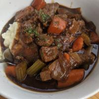Guinness Beef Stew · Tender braised beef with carrots, onions and celery. Served over mashed potatoes.
