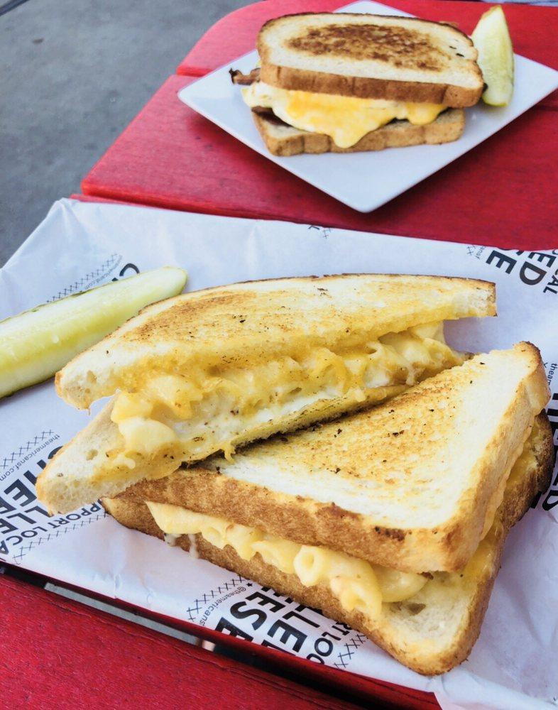 Mac N' Cheese Grilled Cheese Sandwich · Mac and cheese stuffed into a garlic buttered grilled cheese on sourdough.