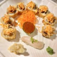 Crown Roll · Deep fried yellowtail, salmon and avocado inside topped with spicy kani and served with swee...