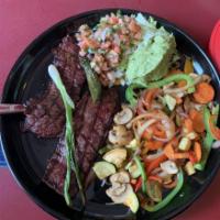 Carne Asada · Broiled petite New York steak. Served with pico de gallo, guacamole, grilled onions and a ja...