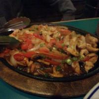Chicken Fajita · A sizzling dish sautéed with green peppers, onions, and mushrooms in a tangy salsa. Served w...