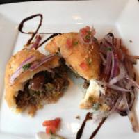 Papa Rellena · Deep-fried mashed potato stuffed with meat sauce and served with salsa criolla.