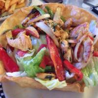 Fajita Salad · Fresh salad greens served with grilled fajita chicken or steak, red and green bell peppers, ...
