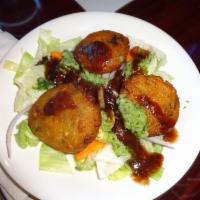 Aloo Tikki · Fried pastry made of potato and herbs, garnished with crunchy salad.