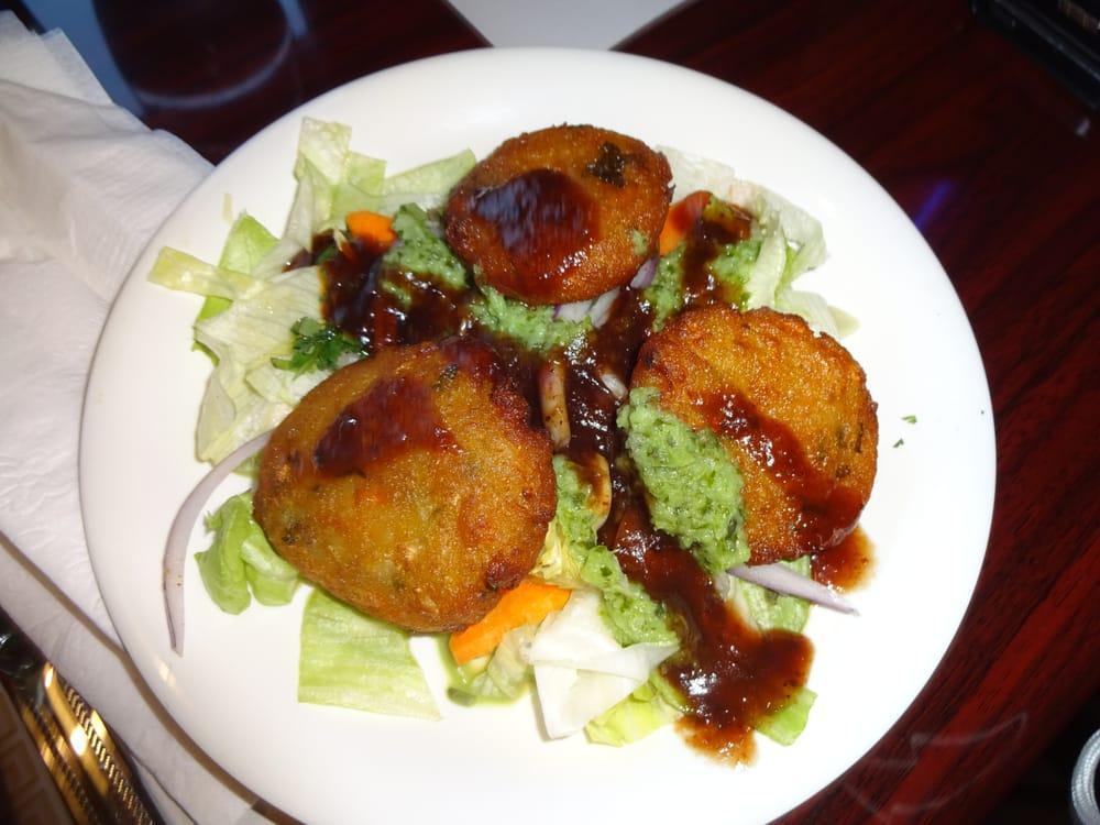 Aloo Tikki · Fried pastry made of potato and herbs, garnished with crunchy salad.