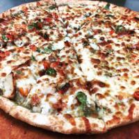 Pesto Lovers Pizza · Pesto sauce, sun dried tomatoes, onions, green and red peppers, chicken and gourmet cheese.