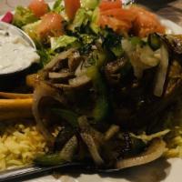 Lamb Shank · Slowly braised fall off the bone tender lamb. Served over saffron rice and house salad. Add ...