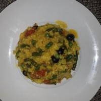 Paella · Shrimp, scallops, mussels, squid, merguez, chicken, peas, and saffron.