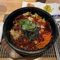 Uncle Kwan's Bi Bim Bop · A new twist to Korea’s traditional dish! Assortment of seasoned vegetables over rice in a si...