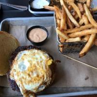 Hangover Burger · Certified Hereford beef hand-pattied in-house, and served on a baked bun with fried egg, che...
