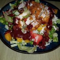 Polynesian Chicken Salad · Coconut, chicken with greens, strawberries, mandarin oranges, peppers, candied pecans, blue ...
