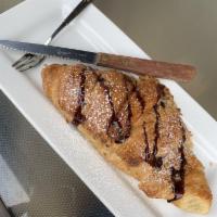 Nutella Croissant · Butter croissant filled with Nutella and topped with powder sugar.