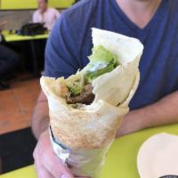 Grilled Gyro Wrap · Marinated lamb and beef served with choice of lettuce, tomatoes, onions, pickles, hummus, ta...