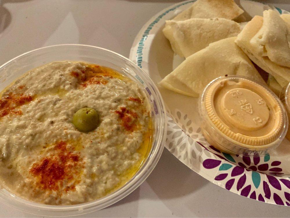 Baba Ghanouj · A textured mix of smokey, roasted eggplant, tahini, lemon, and fresh garlic, with olive oil, served with pita bread.