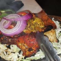 Tandoori Mixed Grill · Shrimp, lamb and chicken grilled in the tandoori oven. Served with basmati rice.