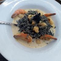 Linguine Nere · Black linguine pasta with bay scallops, bay shrimp, leeks in cream sauce and caviar.