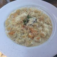 Gnocchi Gratinati · Homemade potato dumplings in a Parmesan cream sauce and au gratin.