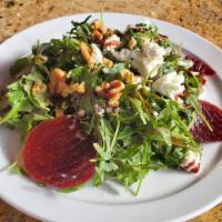 Beet Salad · Roasted red beets, arugula, walnuts, goat cheese and red wine reduction dressing.