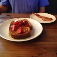 Strawberry French Toast · Our french toast topped with fresh strawberries, whipped cream, and powdered sugar.