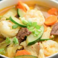 Spicy Korean Noodle Soup · Jung pong style spicy noodle soup with chicken, shrimp, beef, cabbage, carrots and zucchini.