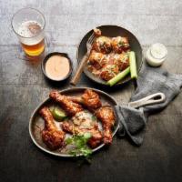 Duck Wings · Crispy duck wings, brick sauce & cilantro with sriracha ranch.