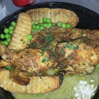 Chicken Vesuvio · Bone In Chicken, Pea's, Roasted Garlic and white wine sauce served with potatoes