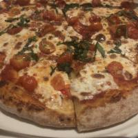 Margherita Pizza · Mozzarella, fresh basil, tomatoes, and San Marzano tomato sauce. Vegetarian.